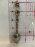 Person Carrying a Baby Souvenir Spoon